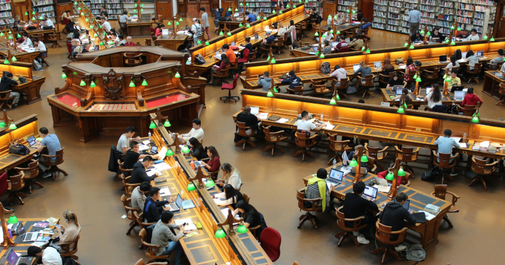 students studying in busy university library