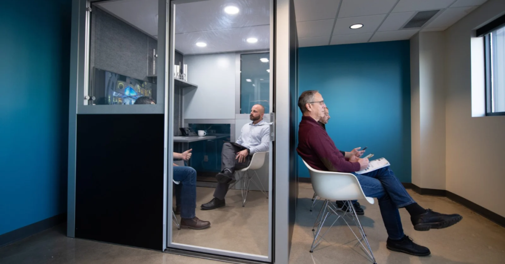 acoustic office pod being used by business professionals